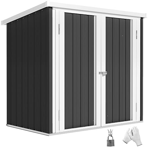 Abri de jardin compact noir en acier galvanisé, avec deux portes et loquet, dans un jardin ordonné